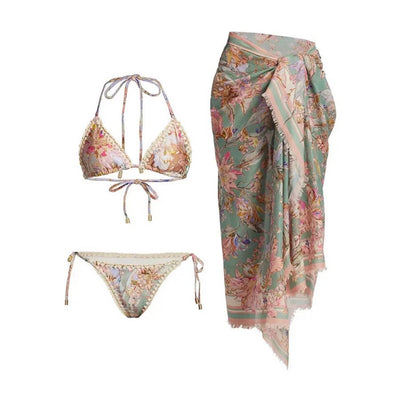 Women's green and pink floral bikini suit with matching sarong. Halter triangle top, tie-side bottoms, and wrap skirt. - Image 2