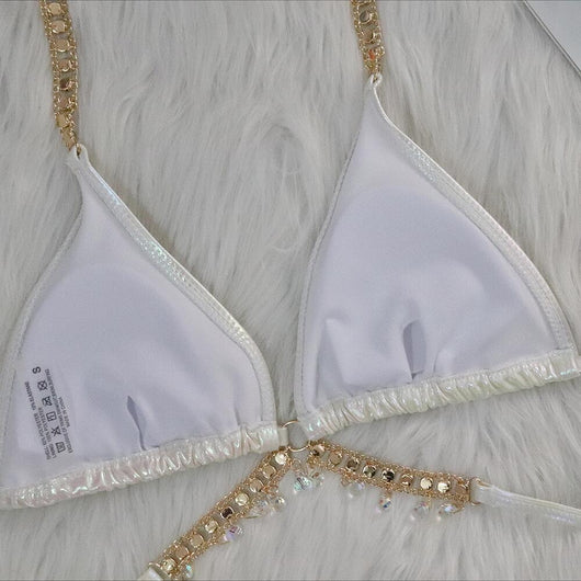 Iridescent purple and pink two-piece bikini with gold-toned crystal embellishments on a white faux fur background. - Image 35