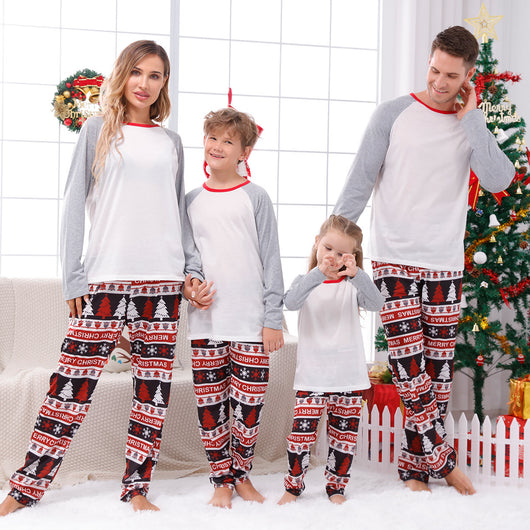 Family of four wearing matching Christmas pajamas with 'MERRY Christmas' text, leopard print, and plaid trees. - Image 3