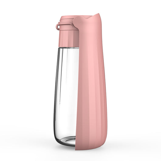 Yellow 450ml portable pet water bottle with a folding drinking trough and white wrist strap, on grass. - Image 4