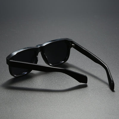 Black square-frame polarized sunglasses with dark lenses, suitable for both men and women, on a dark gray surface. - Image 12