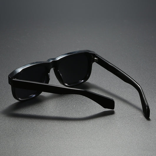 Black square-frame polarized sunglasses with dark lenses, suitable for both men and women, on a dark gray surface. - Image 12