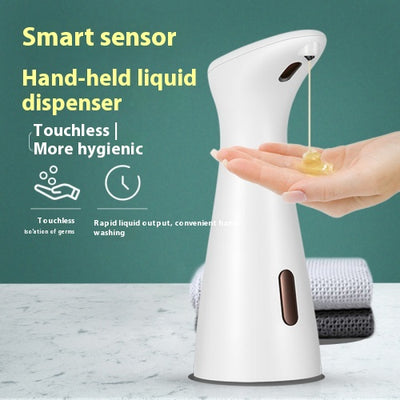 White automatic soap dispenser with an infrared sensor, dispensing blue liquid soap onto an outstretched hand. - Image 7