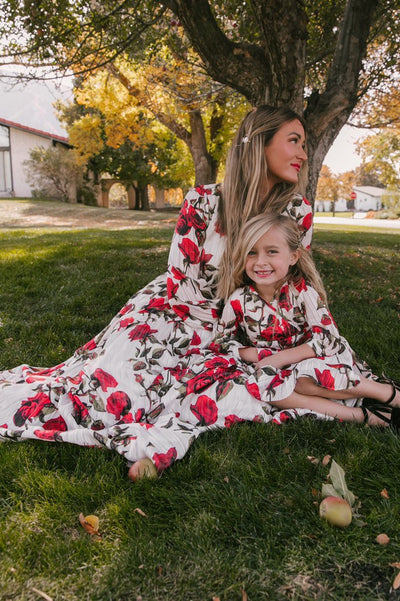 Mother and daughter in matching white dresses with red floral print, V-neck, long sleeves, and tie-waist. - Image 13