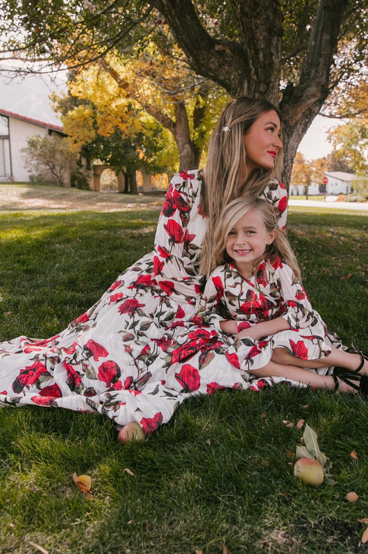Mother and daughter in matching white dresses with red floral print, V-neck, long sleeves, and tie-waist. - Image 13
