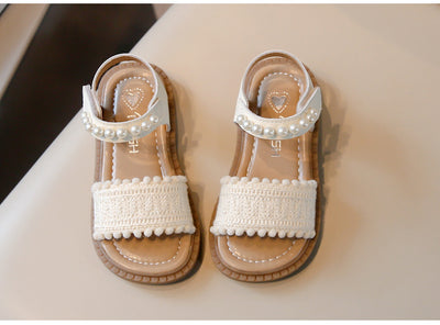 Children's white sandals with pearl ankle straps, woven front strap, and brown sole, featuring a Velcro closure. - Image 14