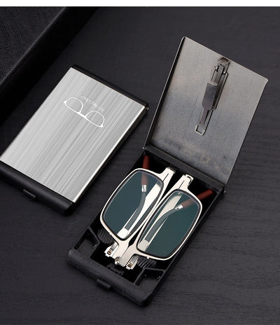 Foldable blue light blocking glasses with silver frames in a black case, shown on a smartphone. - Image 9