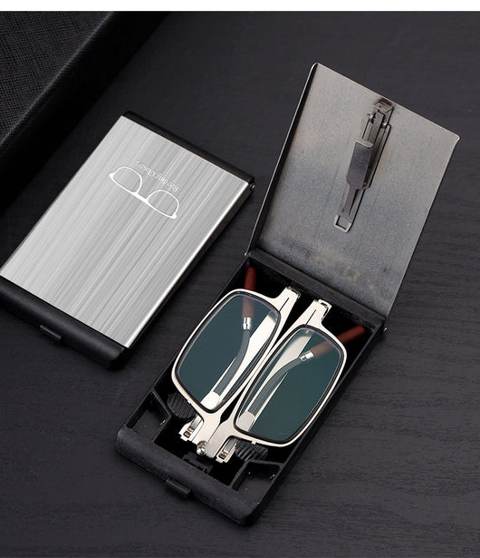 Foldable blue light blocking glasses with silver frames in a black case, shown on a smartphone. - Image 9