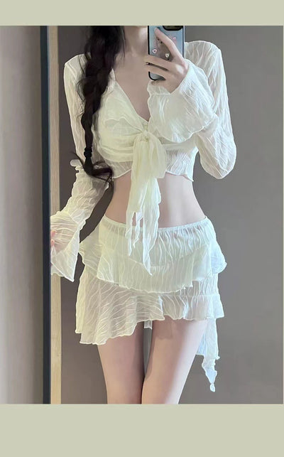 White four-piece bikini swimsuit set for women, featuring a long-sleeve tie-front top and tiered ruffle skirt. - Image 15