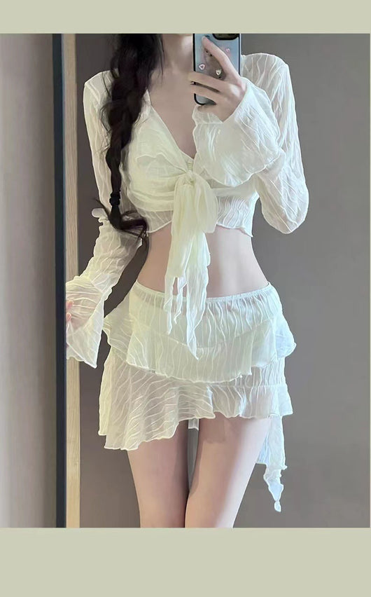 White four-piece bikini swimsuit set for women, featuring a long-sleeve tie-front top and tiered ruffle skirt. - Image 15