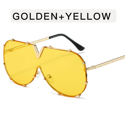 Oversized V-shaped sunglasses with a gold metal frame, white accents, clear lenses, and decorative rivets. - Image 7