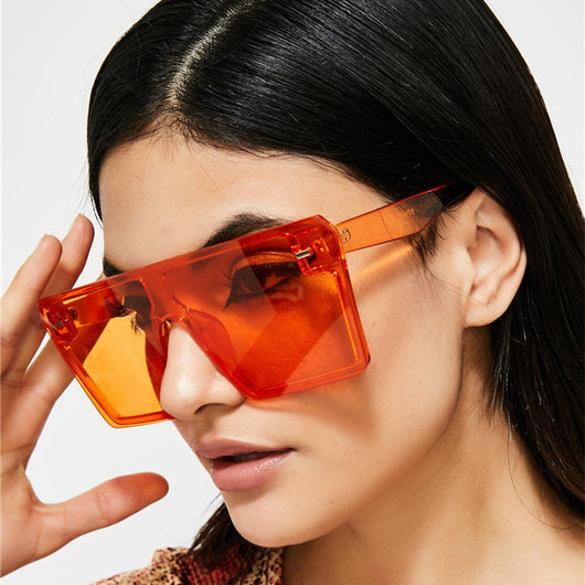 Oversized flat-top sunglasses with translucent red plastic frames and matching red lenses on a white background. - Image 14