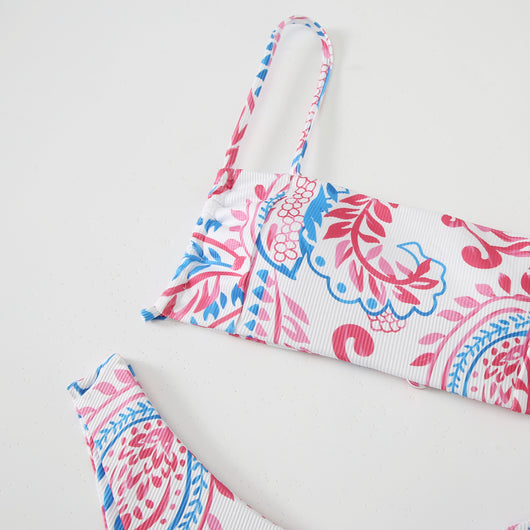 White ribbed two-piece swimsuit with pink and blue paisley floral print, bandeau top, and high-cut bottoms. - Image 13