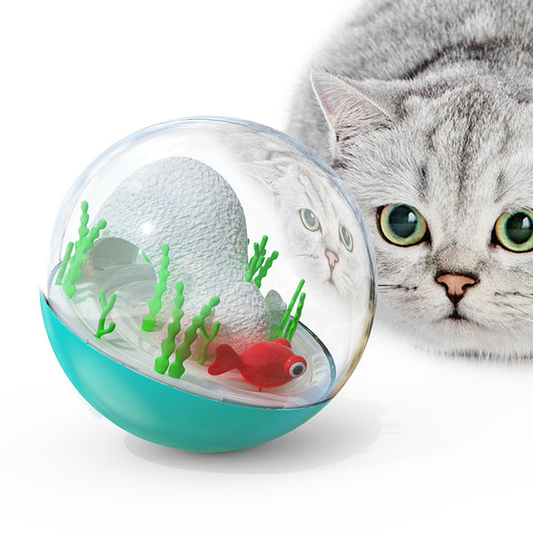 Clear and teal cat toy tumbler with a red fish and green seaweed inside, observed by a curious grey cat. - Image 5