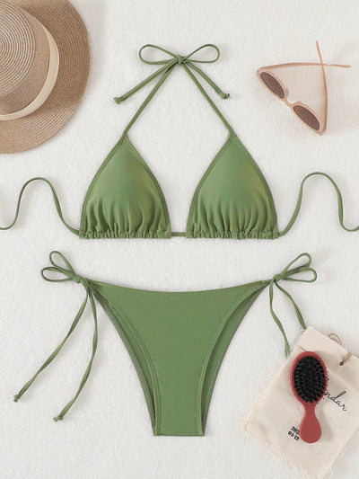 Neon yellow halter bikini with triangle top and tie-side bottoms, displayed on a light wood surface. - Image 39