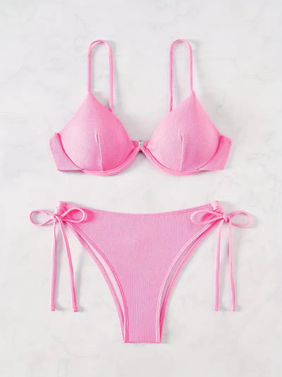 Black ribbed two-piece bikini with an underwire top and tie-side bottoms on a white marble surface. - Image 9