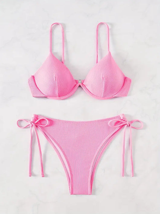 Black ribbed two-piece bikini with an underwire top and tie-side bottoms on a white marble surface. - Image 9
