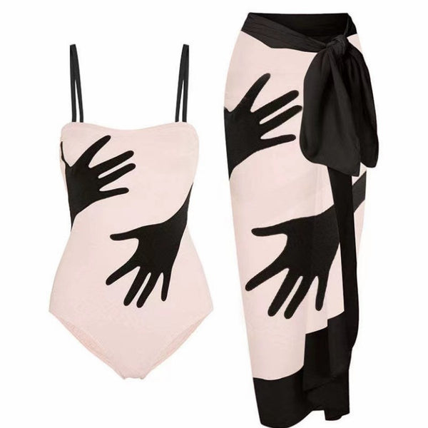 Women's light pink one-piece bikini with black handprint pattern and matching tie-waist sarong. - Image 6