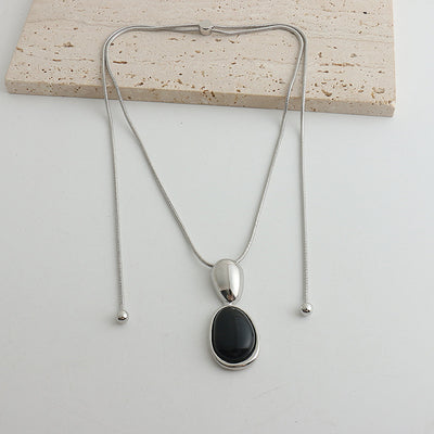 Pair of gold-toned irregular earrings with black onyx-like inserts, featuring a modern, abstract design. - Image 7