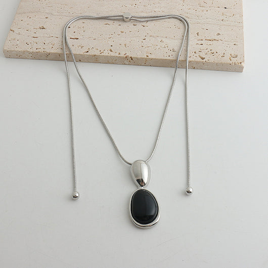 Pair of gold-toned irregular earrings with black onyx-like inserts, featuring a modern, abstract design. - Image 7