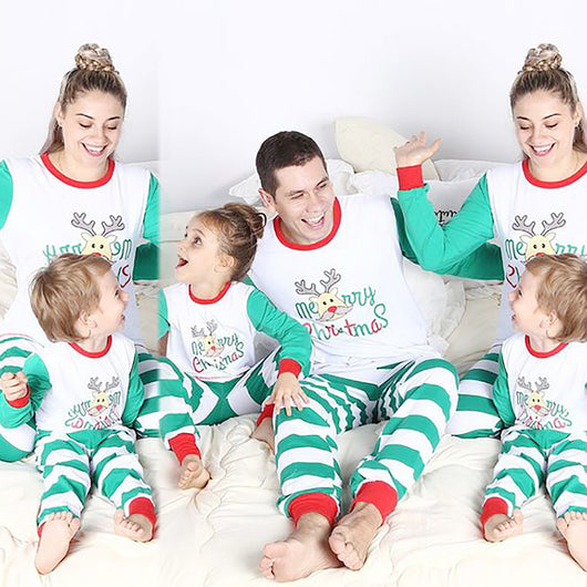 Family of four wearing matching green and white striped Christmas pajamas with a reindeer and "Merry Christmas" text. - Image 4