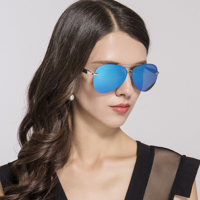 Classic rimless aviator sunglasses with black metal frames and dark black-gray polarized lenses on a white background.