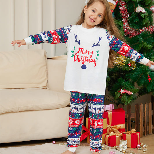 Family of four wearing matching white and red/blue Christmas pajamas with reindeer antlers and 'Merry Christmas' text. - Image 2