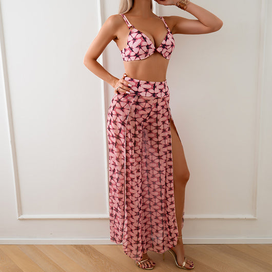 Women's pink, black, and white abstract striped bikini with a push-up top and strappy high-cut bottoms on a beach. - Image 10