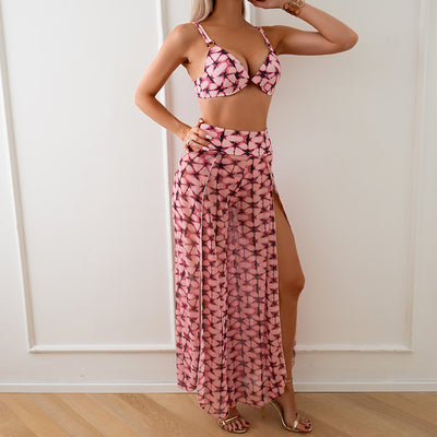 Women's pink, black, and white abstract striped bikini with a push-up top and strappy high-cut bottoms on a beach. - Image 10