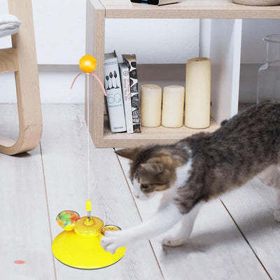 Tabby cat playing with a yellow suction cup cat toy featuring a spring-mounted teaser wand with an orange fur ball. - Image 5