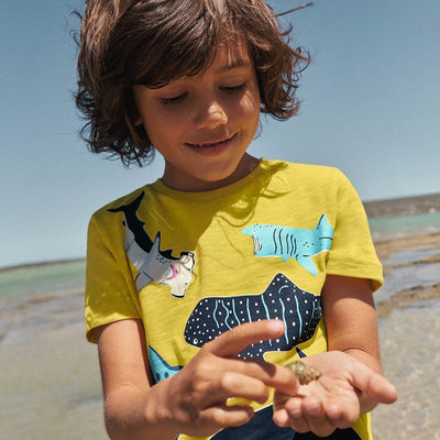 Dark blue short-sleeved children's t-shirt with multiple glowing jellyfish graphics and a yellow neck trim. - Image 3