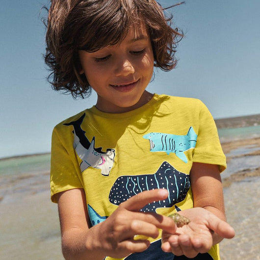 Dark blue short-sleeved children's t-shirt with multiple glowing jellyfish graphics and a yellow neck trim. - Image 3