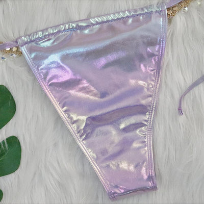 Iridescent purple and pink two-piece bikini with gold-toned crystal embellishments on a white faux fur background. - Image 16