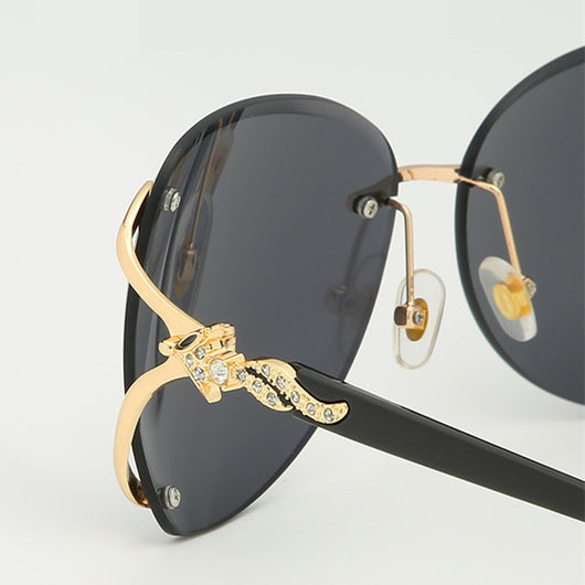 Oversized rimless sunglasses with gradient gray lenses and silver-tone metal accents, displayed on a white surface. - Image 5