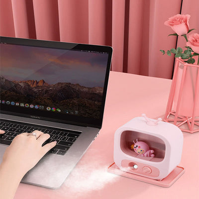 Pink TV-shaped desktop humidifier with a cute pink caterpillar figure inside, featuring a mist outlet and control knob. - Image 15