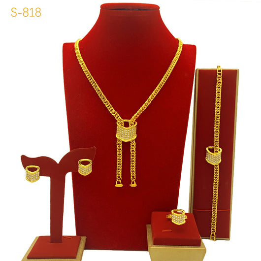 Gold-plated four-piece jewelry set with teardrop rhinestone necklace, bracelet, earrings, and ring on red velvet stands. - Image 6