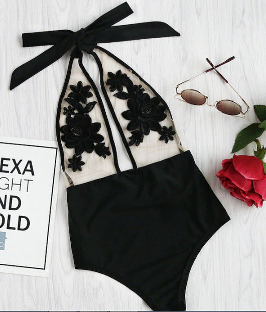 Black one-piece bikini with halter neck, sheer mesh top, and intricate black floral applique details. - Image 9