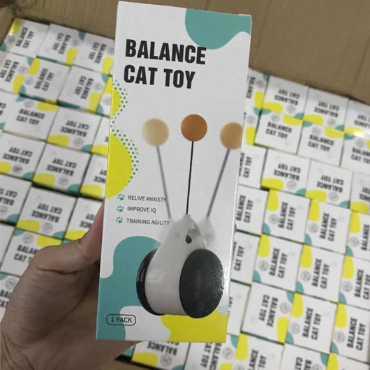 White and black self-rotating cat toy with an orange ball on a flexible rod, showing motion blur. - Image 26