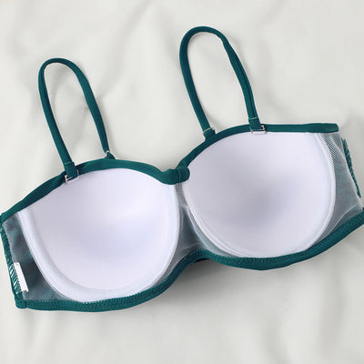 Teal twisted bandeau bikini top with tropical leaf print high-waisted bottoms on a model wearing a white shirt. - Image 22