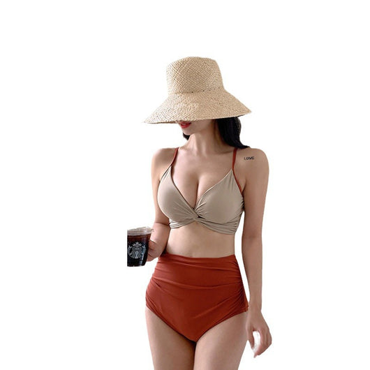 Woman in a blue twisted triangle bikini top and white high-waisted bottoms, holding a leaf-print cover-up. - Image 5