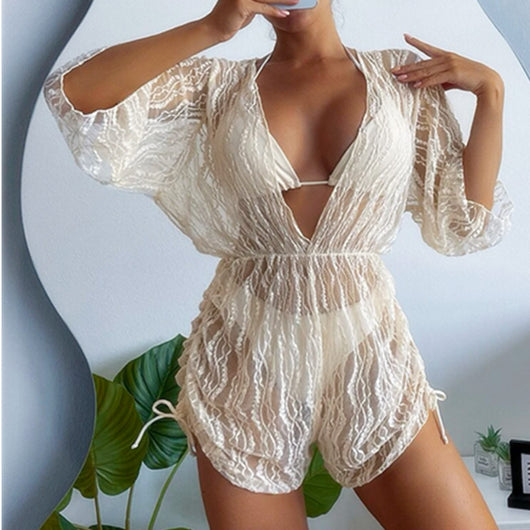 Woman wearing a white and black tie-dye beach cover-up romper with a deep V-neck and drawstring sides. - Image 14
