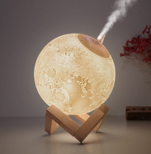 Moon-shaped humidifier and night light with a white deer stand, emitting mist, on a wooden table with books. - Image 8