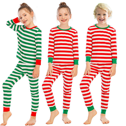 Girl wearing red and white striped long-sleeved pajamas with green trim on collar and cuffs. - Image 5
