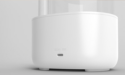 White and clear humidifier with a visible water vortex, emitting mist, and featuring a rose gold accent. - Image 16