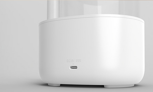 White and clear humidifier with a visible water vortex, emitting mist, and featuring a rose gold accent. - Image 16