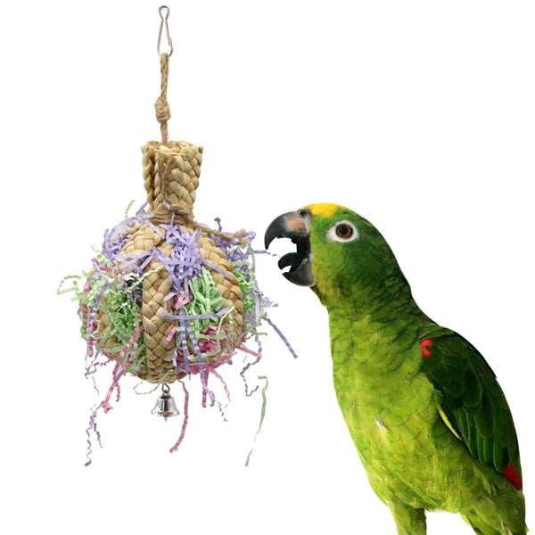 Woven straw paper parrot toy filled with colorful shredded paper, featuring a small bell at the bottom.