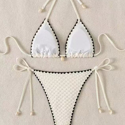 Black textured bikini with white scalloped trim, halter top, and tie-side bottoms featuring small shell details. - Image 4