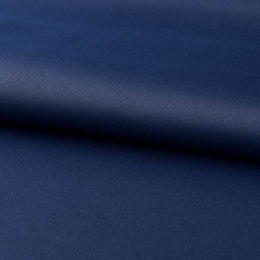 Dark blue blackout curtains with silver grommet tops hanging on a rod in a modern bedroom setting. - Image 10