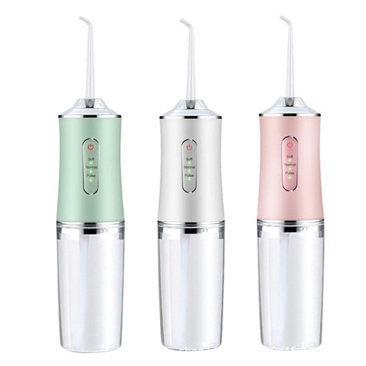 Pink portable electric oral irrigator with clear water tank and four nozzles, highlighting adjustable pressure and pulse mode.