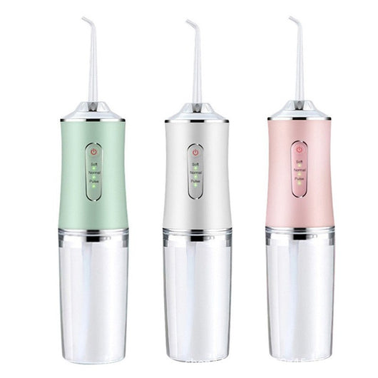 Pink portable electric oral irrigator with clear water tank and four nozzles, highlighting adjustable pressure and pulse mode.